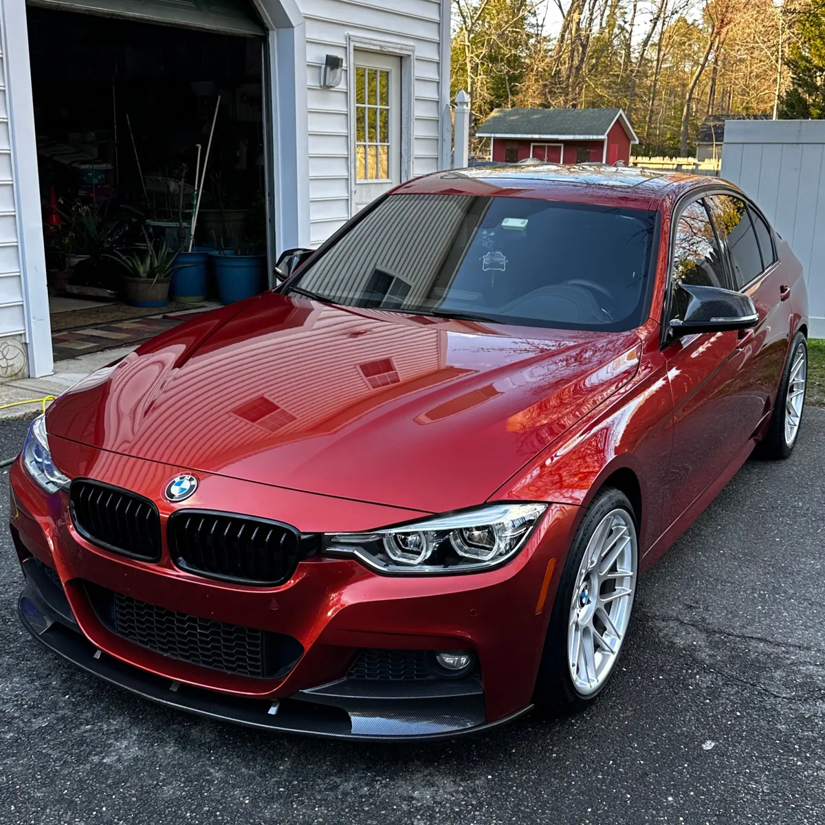 Red BMW 3 Series with a deep wet-look finish after a full detail