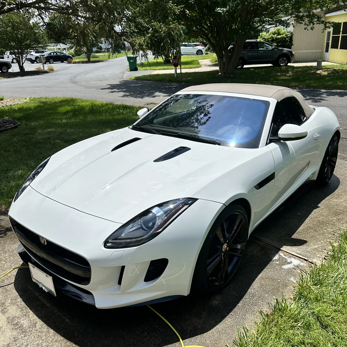 White Jaguar F-Type finished and drying in a driveway